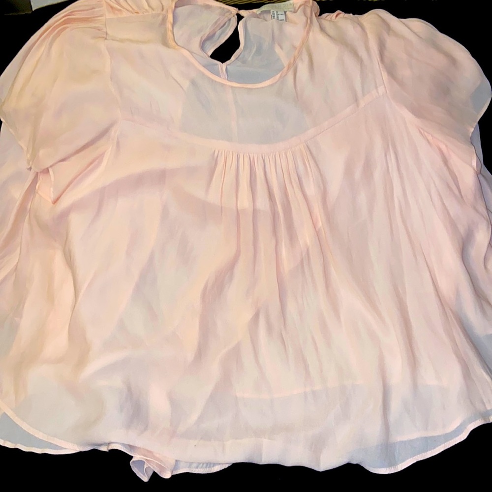 Cream or Peach Chiffon blouse with a button in the back around the neck.